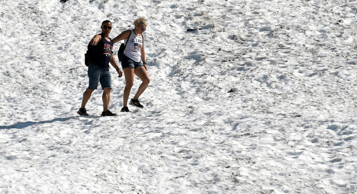 People hike on the Byron Glacier on Thursday in Girdwood, Alaska, southeast of Anchorage. Many cities set heat records amid unusually hot and dry conditions in the area. CREDIT: Lance King/Getty Images