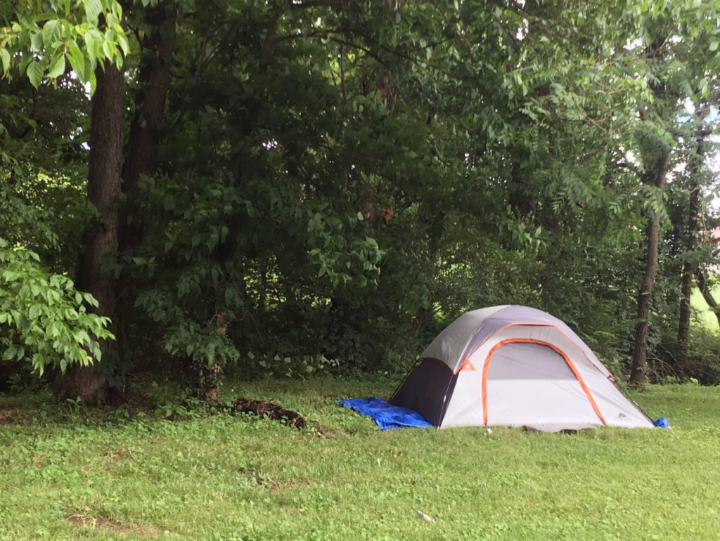 Homeless residents often live outdoors in tents in rural Kentucky. Rarely pitched out in the open, like this one in Lexington, most are hidden in thick bushes of wooded areas. CREDIT: Mary Meehan/WEKU
