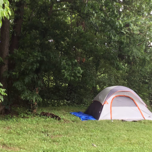 Homeless residents often live outdoors in tents in rural Kentucky. Rarely pitched out in the open, like this one in Lexington, most are hidden in thick bushes of wooded areas. CREDIT: Mary Meehan/WEKU