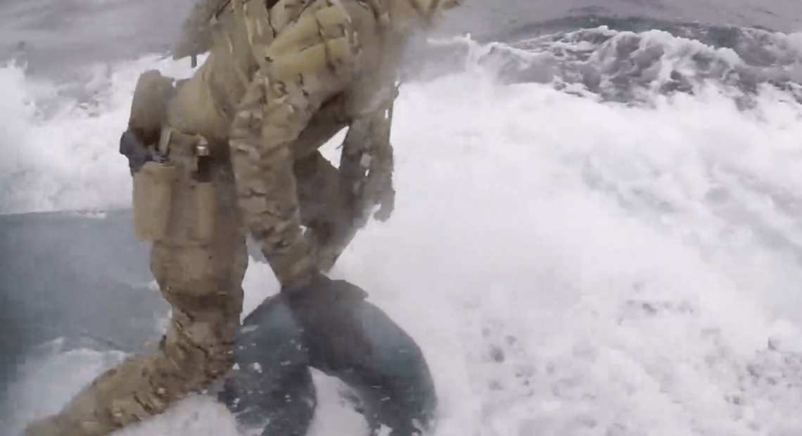 U.S. Coast Guard Cutter Munro crew members board a semi-submersible suspected of carrying drugs on June 18 while operating in international waters of the Eastern Pacific Ocean. U.S. Coast Guard