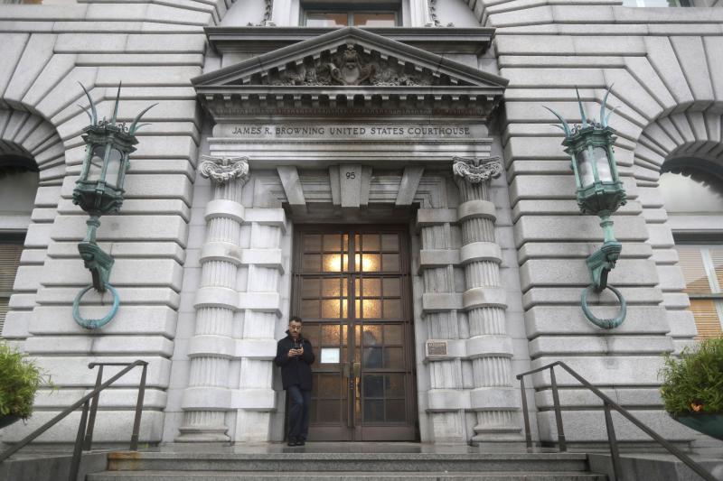 A person stands outside of the 9th Circuit Court of Appeals building in San Francisco. MARCIO JOSE SANCHEZ / AP