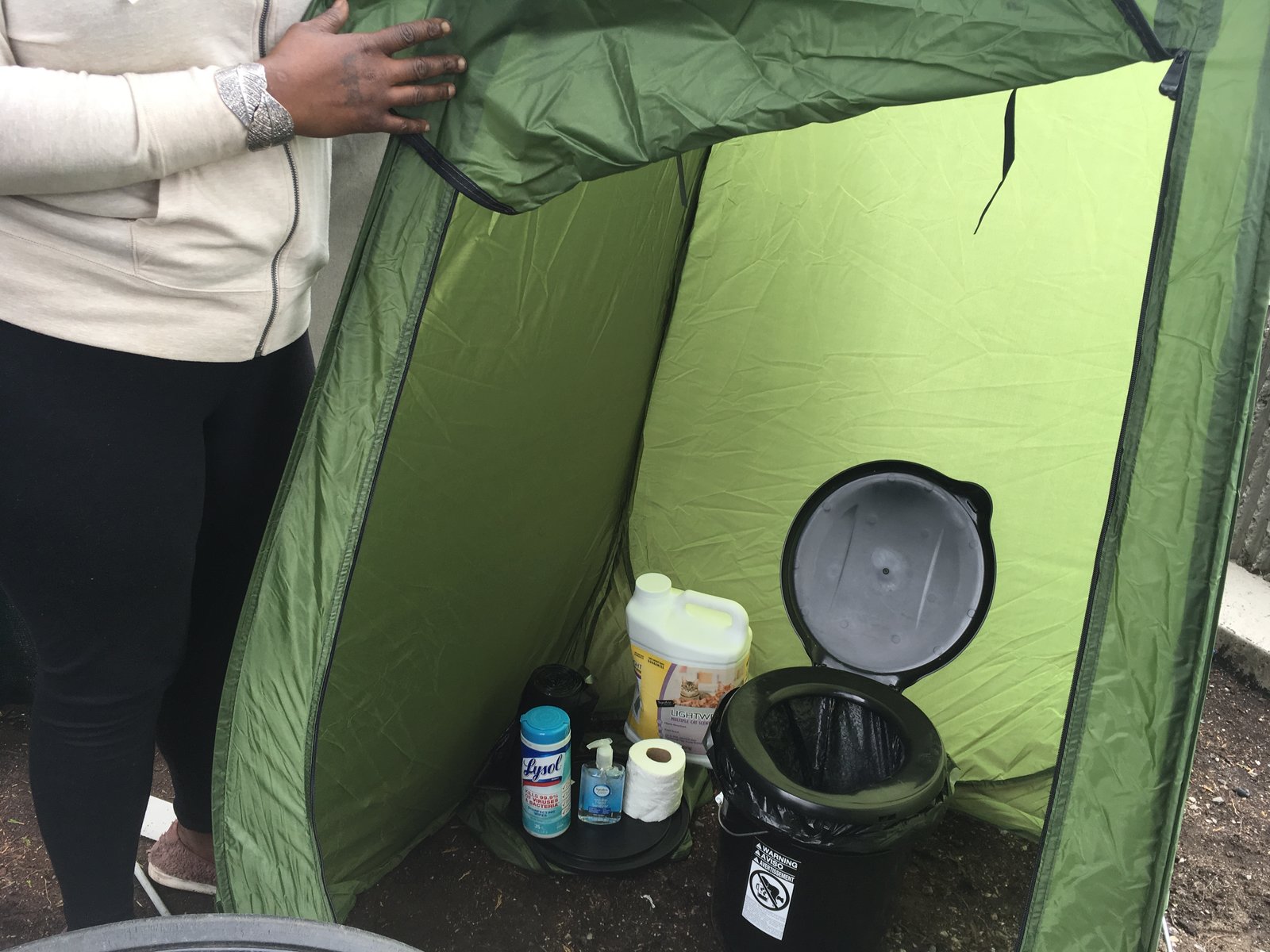 The basic toilet kit that Mark Lloyd distributes to homeless camps in Seattle includes a tent, bucket, seat, cat litter, toilet paper and sanitizer. CREDIT: Gabriel Spitzer/KNKX