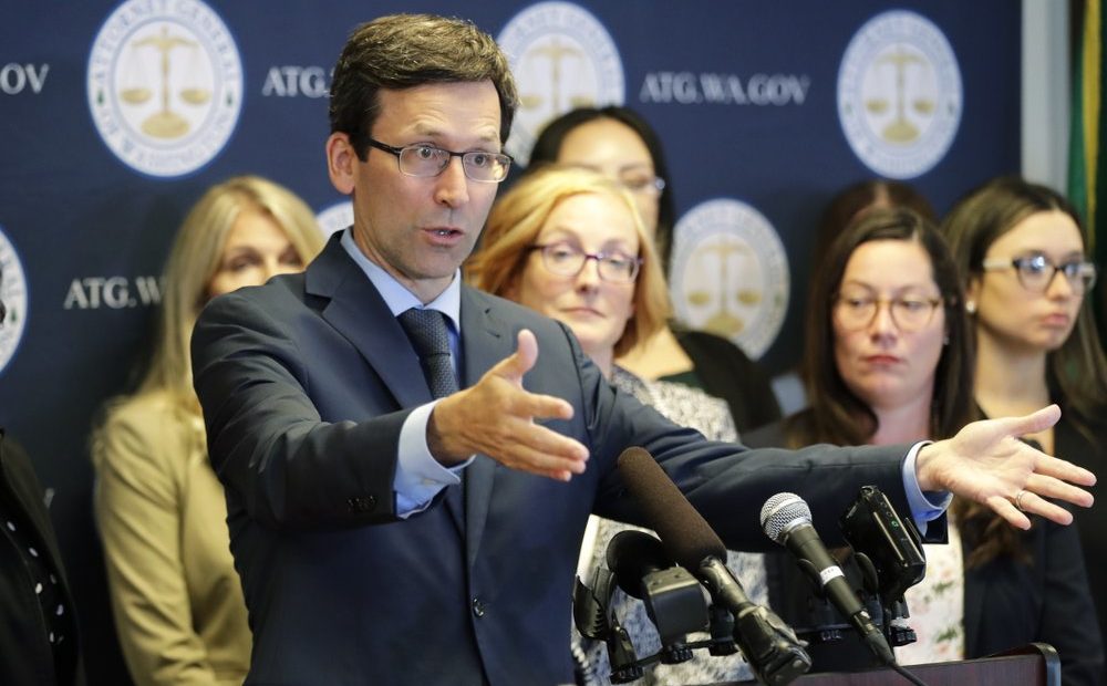 Washington Attorney General Bob Ferguson talks to reporters, Aug. 26, 2019, during a news conference in Seattle. Nineteen states, including Washington, are suing over the Trump administration's effort to alter a federal agreement that limits how long immigrant children can be kept in detention. CREDIT: TED S. WARREN/AP