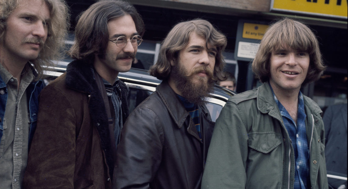 The original lineup of Creedence Clearwater Revival, at London's Heathrow Airport. L-R: Tom Fogerty, Stu Cook, Doug Clifford, John Fogerty. CREDIT: Michael Putland/Getty Images