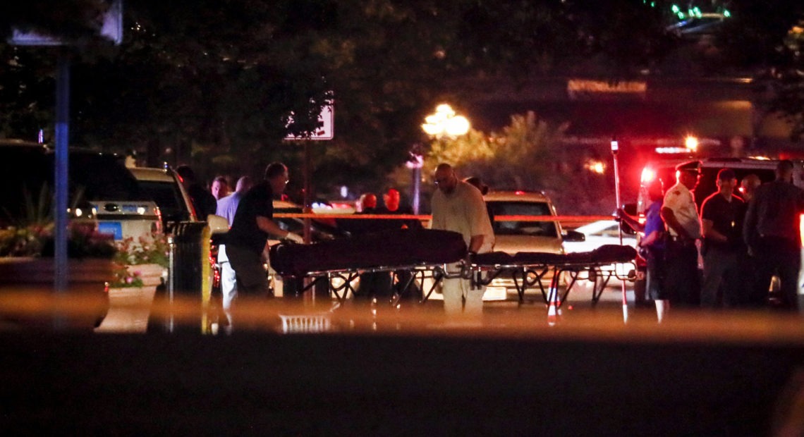 Bodies are removed from the scene of Sunday's mass shooting in Dayton, Ohio. John Minchillo/AP