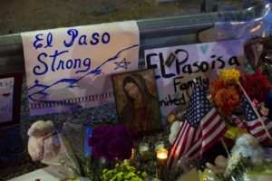 Virgin Mary painting, flags and flowers adorn a makeshift memorial for the victims of Saturday's mass shooting at a shopping complex in El Paso, Texas, Sunday, Aug. 4, 2019. Andres Leighton/AP