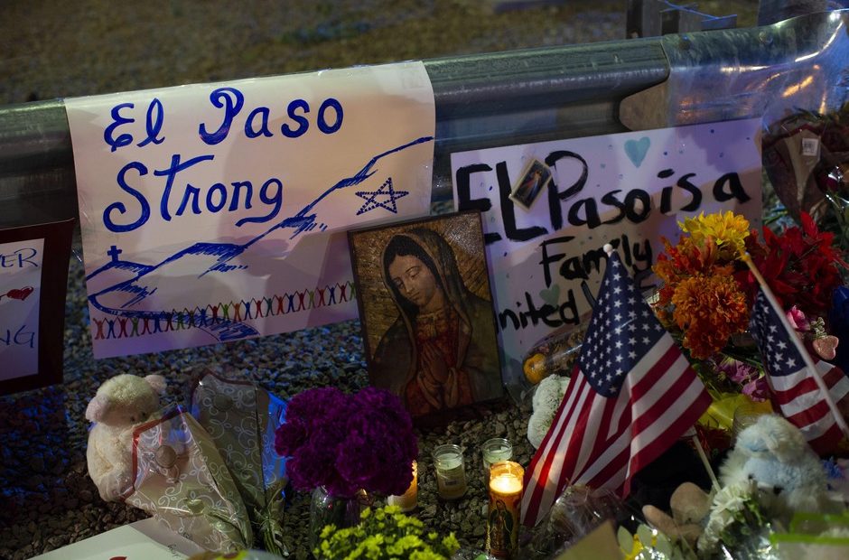 Virgin Mary painting, flags and flowers adorn a makeshift memorial for the victims of Saturday's mass shooting at a shopping complex in El Paso, Texas, Sunday, Aug. 4, 2019. Andres Leighton/AP