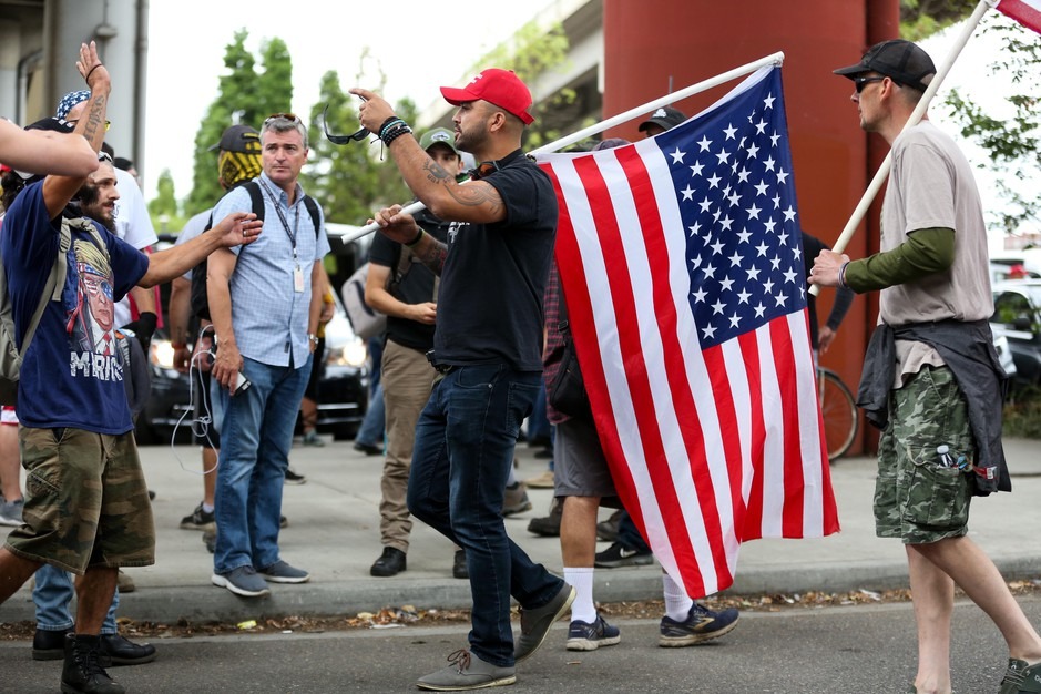 Patriot Prayer leader Joey Gibson directs people back to the west side of the Willamette River during demonstrations in Portland, Ore., Saturday, Aug. 17, 2019. CREDIT: Bradley W. Parks/OPB