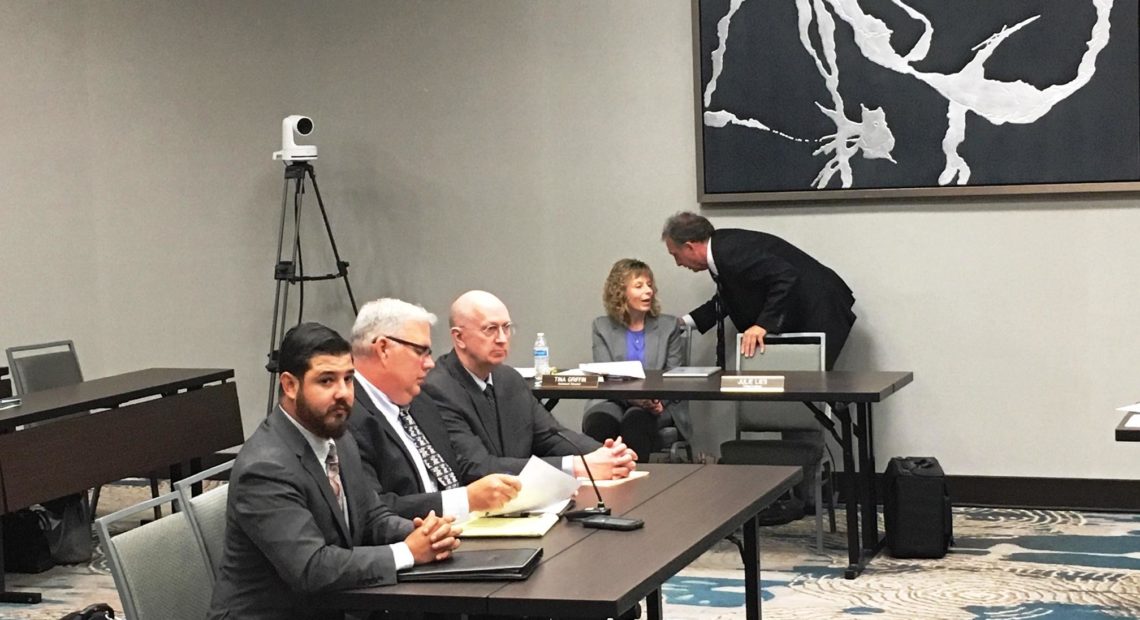 Michael Herrera, left, and Bradley Kruger, center, of the National Rifle Association at a Washington State Gambling Commission Meeting AUSTIN JENKINS / NORTHWEST NEWS NETWORK