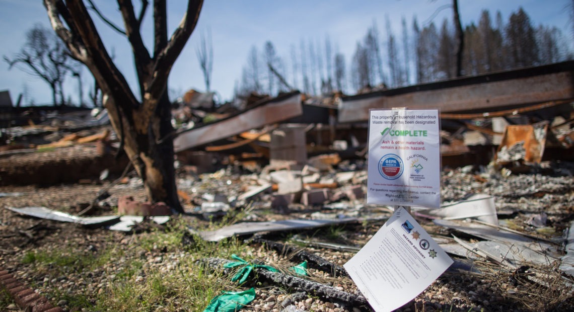 A mobile home park destroyed by last year's wildfire in Paradise, California. Those rebuilding homes and lives say they're getting contradictory messages about whether the water is safe to drink. CREDIT: Meredith Rizzo/NPR