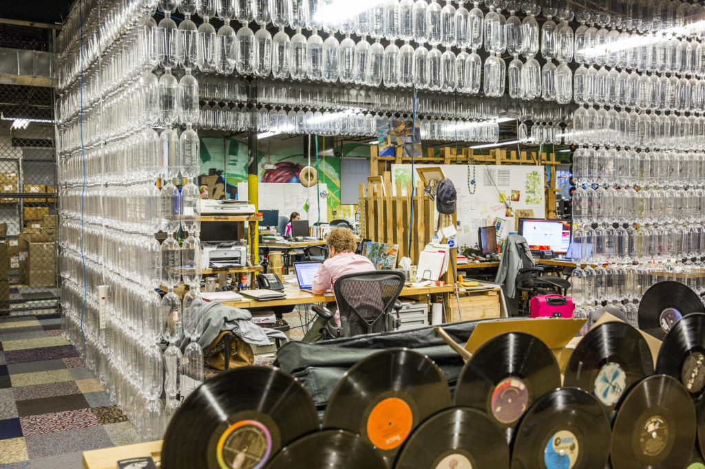 Plastic bottles surround an employee at a workstation inside recycling company TerraCycle's headquarters in Trenton, N.J., in 2017. David Williams/Bloomberg via Getty Images