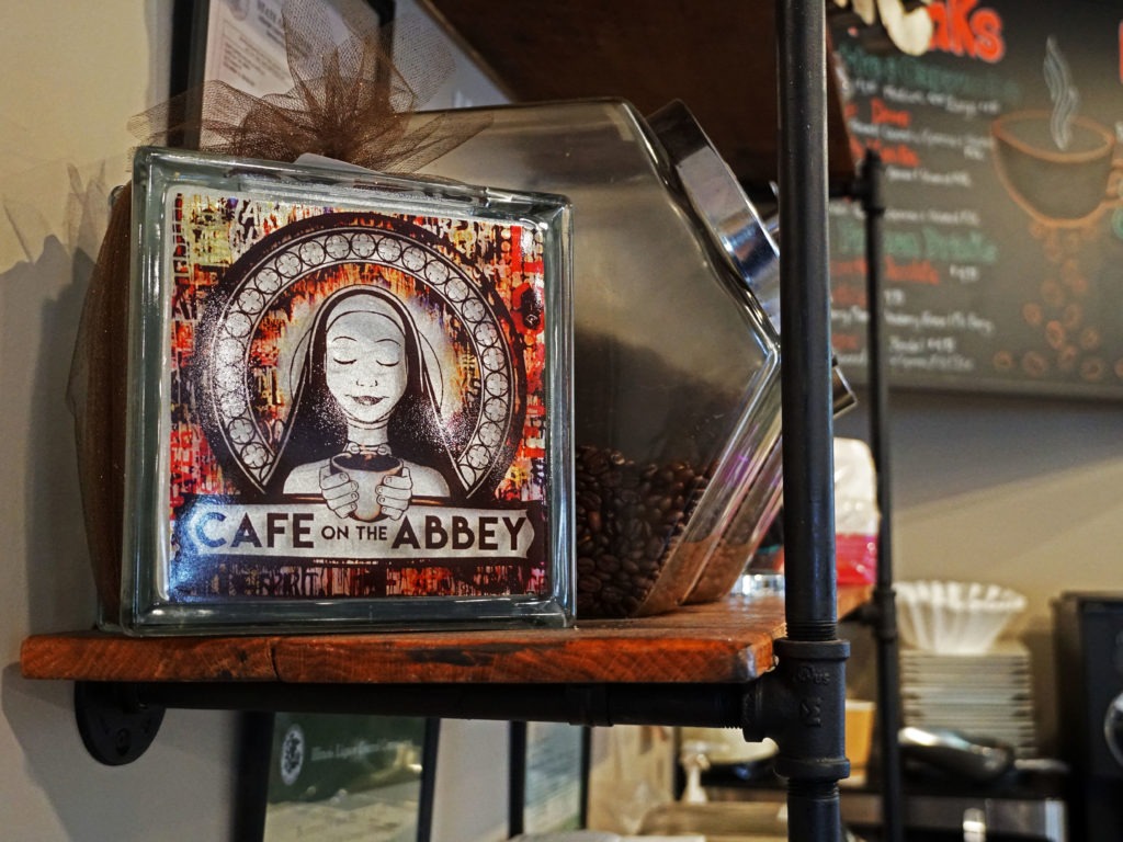 Cafe on the Abbey co-owner Danny Ball calls its logo of a nun drinking coffee "playful and respectful." The coffee shop is one part of a multimillion-dollar development in Columbia, Ill. Shahla Farzan/St. Louis Public Radio
