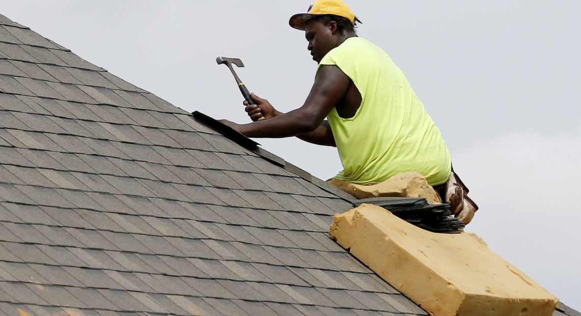 A construction worker lays down shingles on the roof of a new house in Brandon, Miss., on June 19. Construction jobs rose 4,000 in July — below the 18,000 added in June and the 19,000 added in July 2018.CREDIT: Rogelio V. Solis/AP