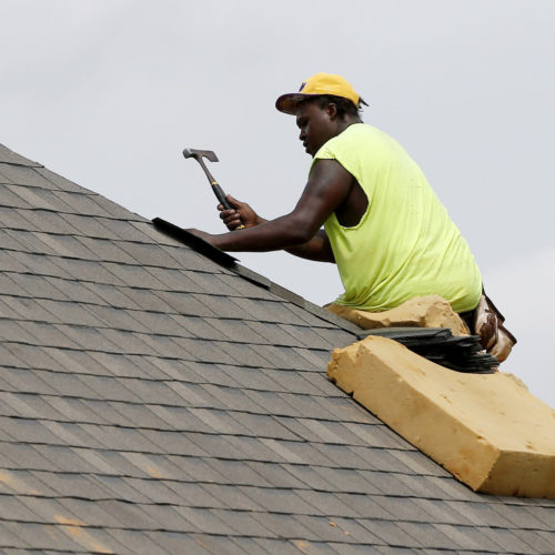 A construction worker lays down shingles on the roof of a new house in Brandon, Miss., on June 19. Construction jobs rose 4,000 in July — below the 18,000 added in June and the 19,000 added in July 2018.CREDIT: Rogelio V. Solis/AP