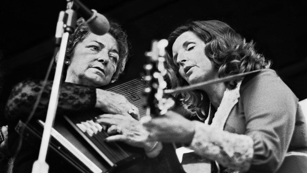 Maybelle Carter, playing her autoharp, performs with her daughter, Helen. Robert Alexander/Getty Images
