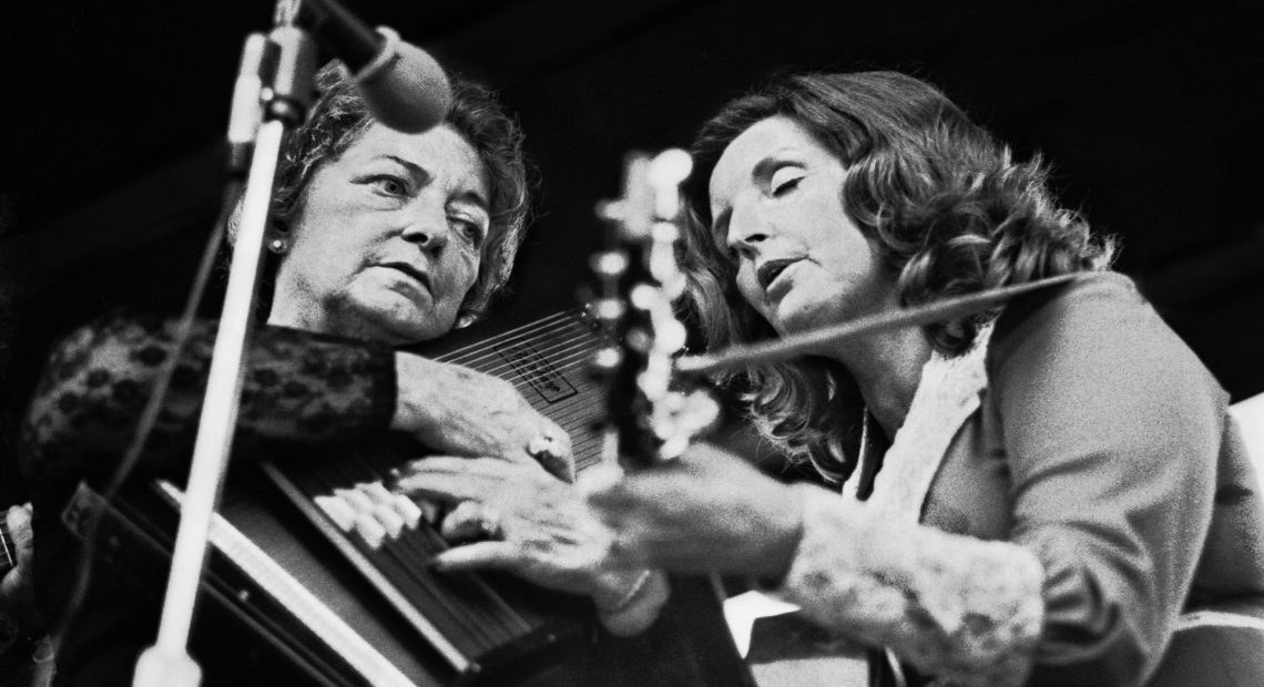Maybelle Carter, playing her autoharp, performs with her daughter, Helen. Robert Alexander/Getty Images