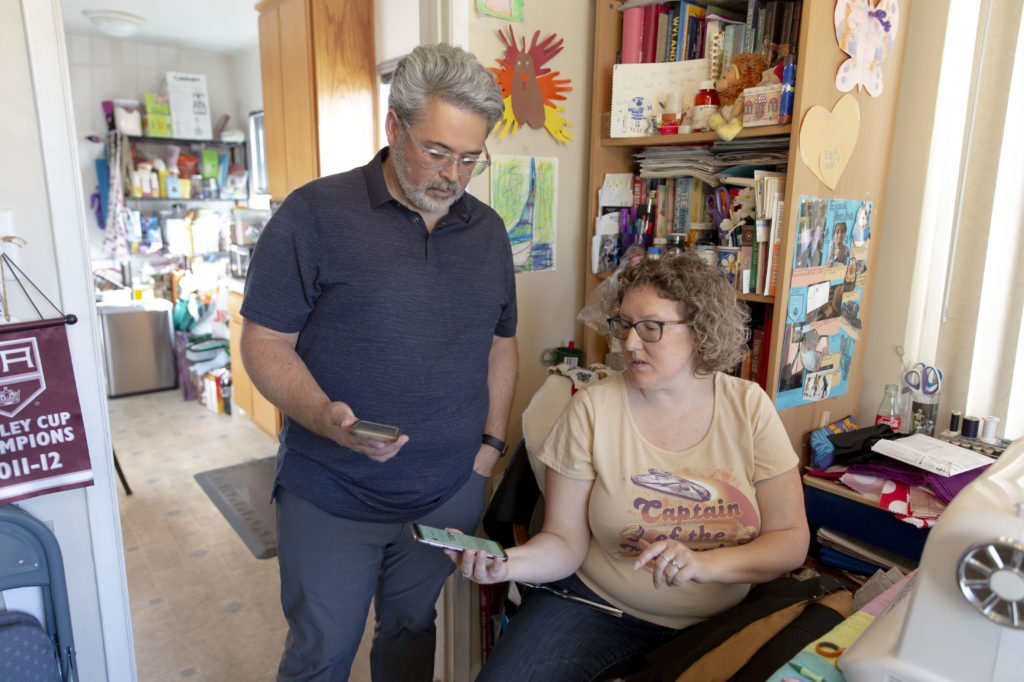 Ric Peralta and his wife Lisa are both able to check Ric's blood sugar levels at any time, using the Dexcom app and an arm patch that measures the levels and sends the information wirelessly. Allison Zaucha for NPR