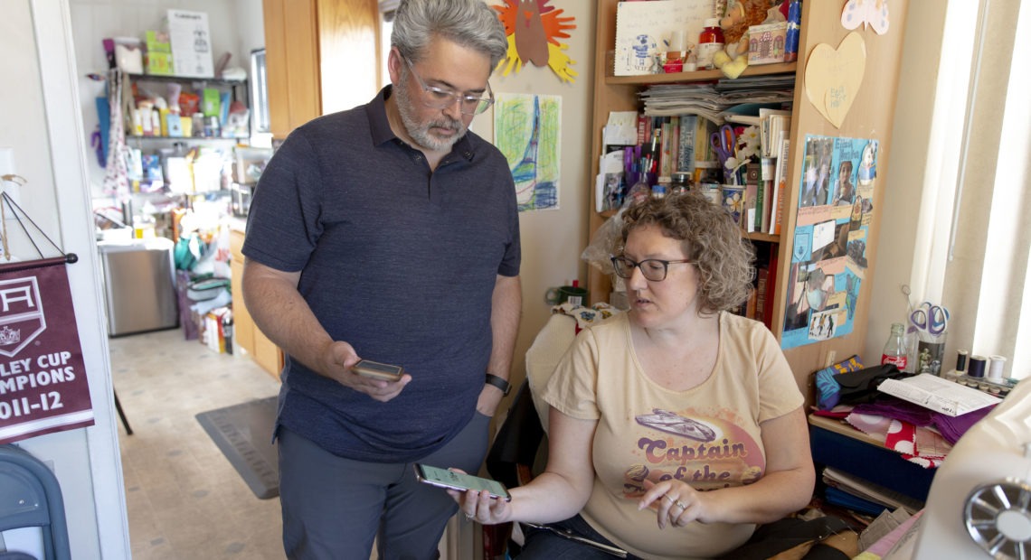 Ric Peralta and his wife Lisa are both able to check Ric's blood sugar levels at any time, using the Dexcom app and an arm patch that measures the levels and sends the information wirelessly. Allison Zaucha for NPR