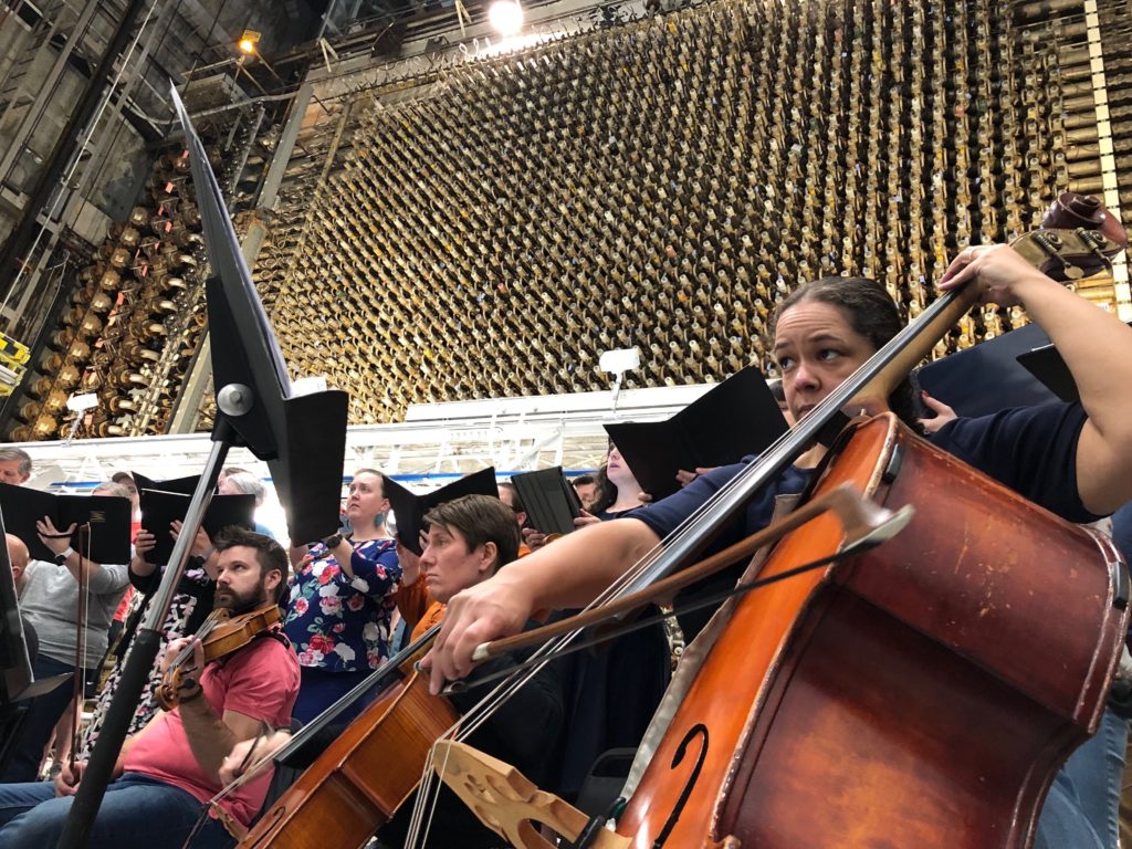 The orchestra practices the new oratorio, “Nuclear Dreams” in front of the B Reactor’s face at Hanford. CREDIT: ANNA KING/N3