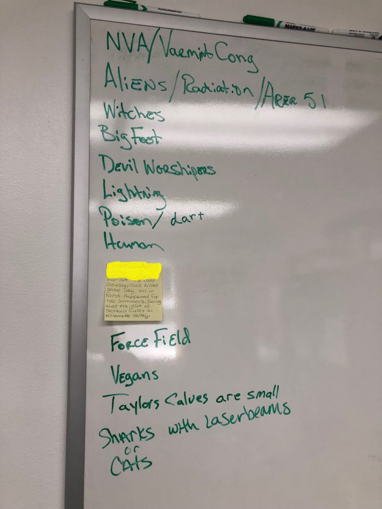 A whiteboard list tracks the theories called in to the Harney County Sheriff's Office. Few clues have led to a lot of spectualion and guesses on how several bulls were mysteriously cut down this summer. (Note: The image has been edited to obscure personal information of someone who had called the sheriff’s office.) CREDIT: ANNA KING/N3