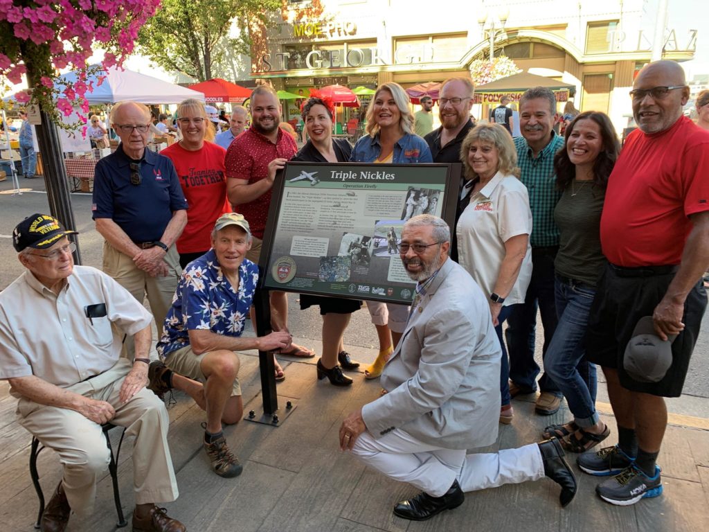 Eastern Washington University senior lecturer Bob Bartlett, kneeling lower right, poses alongside other history buffs beside the new historical marker for the Triple Nickles in Pendleton on Aug. 30. CREDIT: TOM BANSE / N3