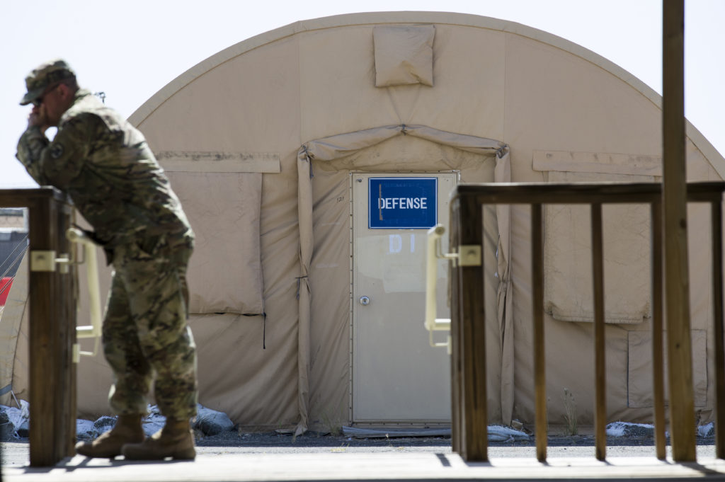 A U.S. Army soldier stands near a tent used by the defense teams for storage at Camp Justice on April 18, 2019, in Guantánamo Bay, Cuba. Alex Brandon/AP