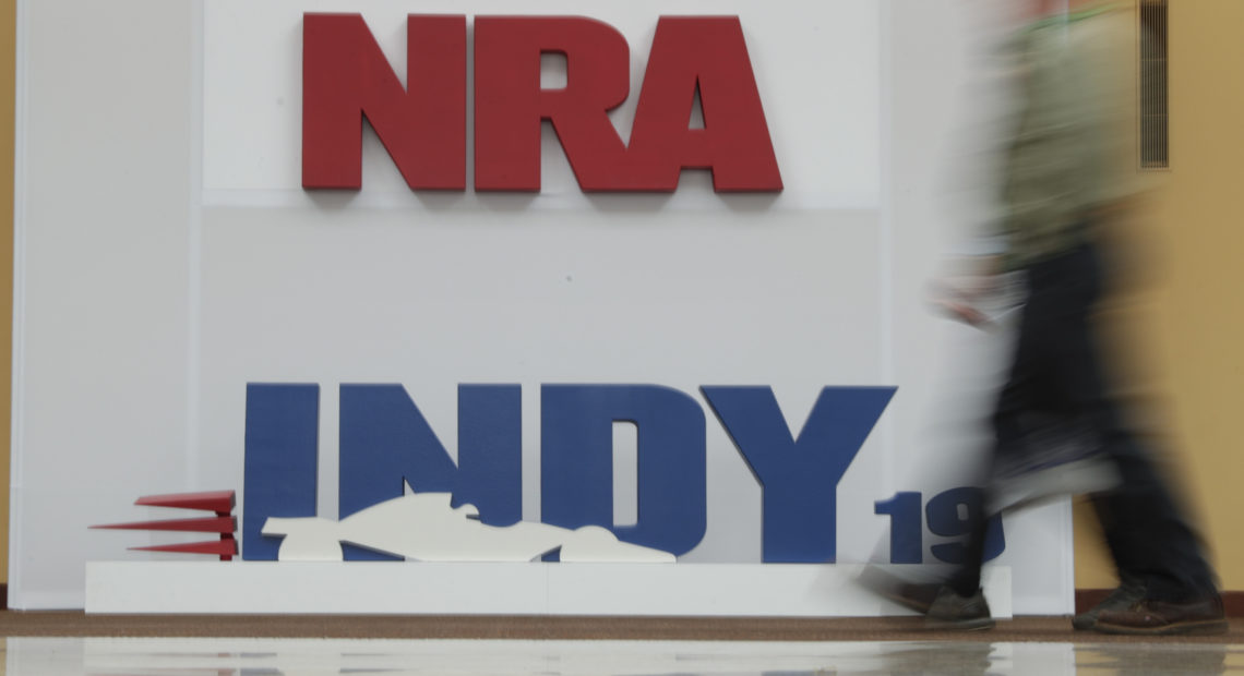 A visitor to the at the National Rifle Association annual meeting walked past signage for the event in Indianapolis, Saturday, April 27, 2019. Michael Conroy/AP