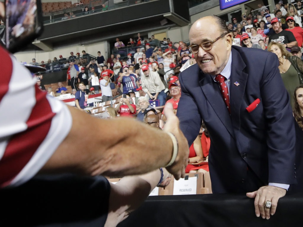 Former New York City Mayor Rudy Giuliani shook hands with supporters as he arrived at President Trump's campaign rally on Aug. 15, 2019, in Manchester, N.H. Elise Amendola/AP