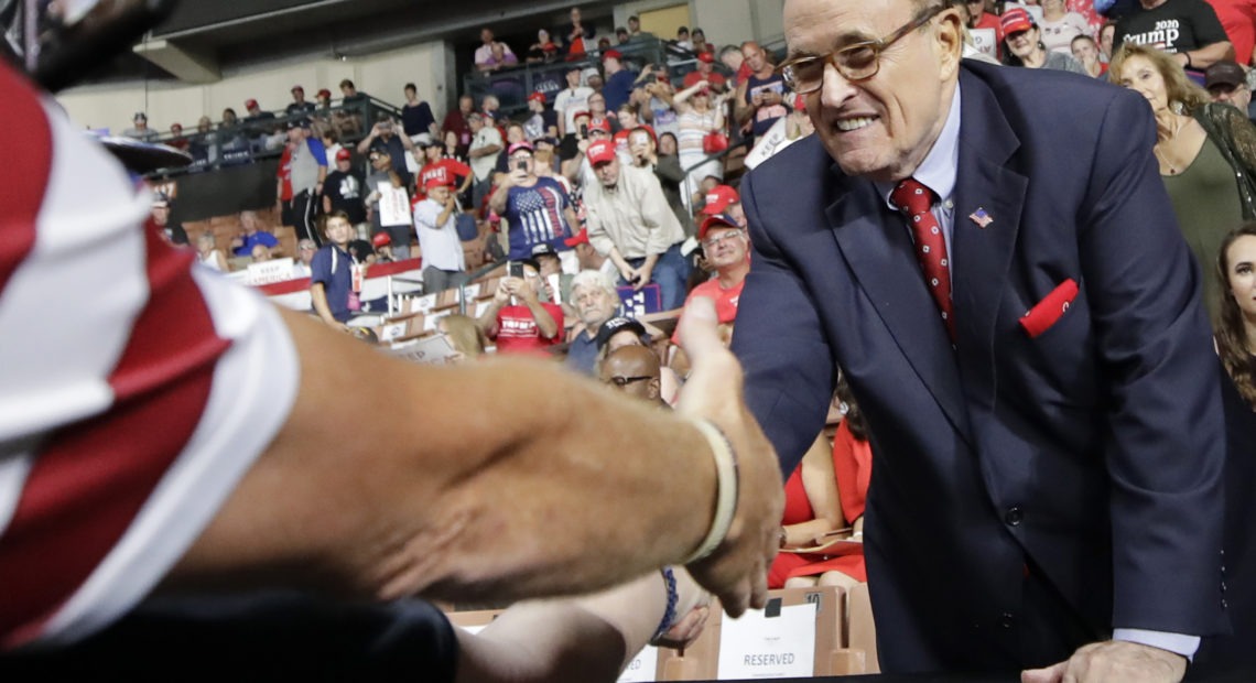 Former New York City Mayor Rudy Giuliani shook hands with supporters as he arrived at President Trump's campaign rally on Aug. 15, 2019, in Manchester, N.H. Elise Amendola/AP