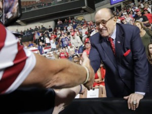 Former New York City Mayor Rudy Giuliani shook hands with supporters as he arrived at President Trump's campaign rally on Aug. 15, 2019, in Manchester, N.H. Elise Amendola/AP