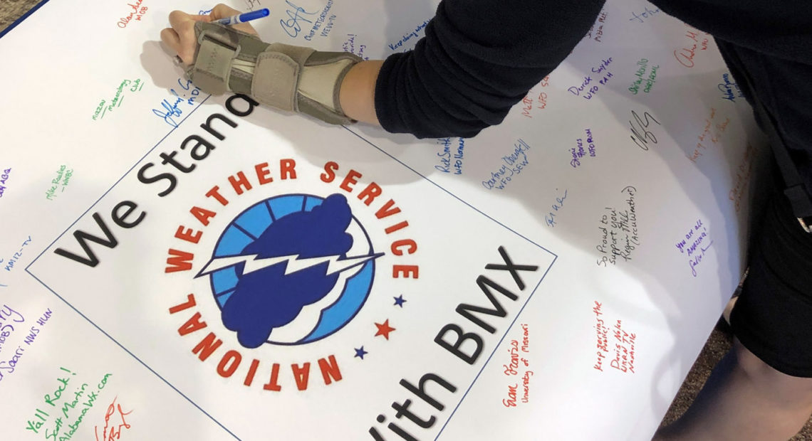 Christina Crowe signs a poster in support of the National Weather Service office in Birmingham, Ala., during a convention of the National Weather Association in Huntsville, Ala., Monday. Jay Reeves/AP