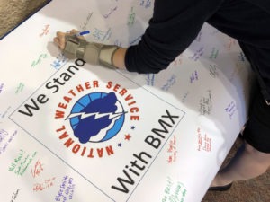 Christina Crowe signs a poster in support of the National Weather Service office in Birmingham, Ala., during a convention of the National Weather Association in Huntsville, Ala., Monday. Jay Reeves/AP