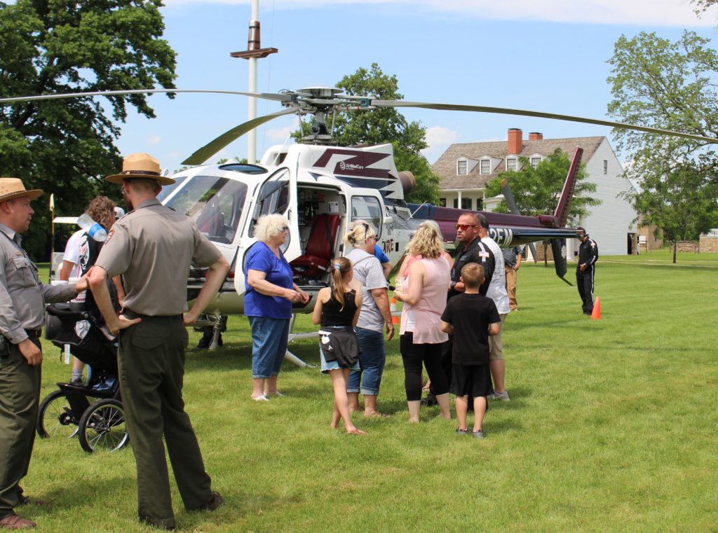 Visitors and park rangers at historic Fort Scott check out a medevac helicopter operated by Midwest AeroCare during the Kansas town's Good Ol' Days festival. Sarah Jane Tribble/Kaiser Health News