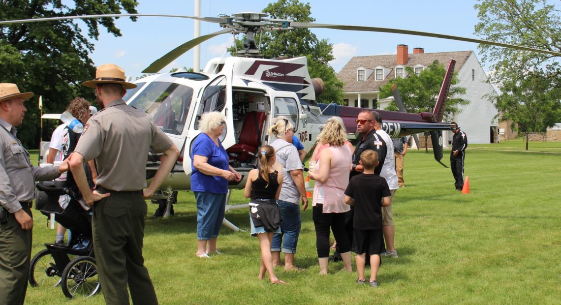 Visitors and park rangers at historic Fort Scott check out a medevac helicopter operated by Midwest AeroCare during the Kansas town's Good Ol' Days festival. Sarah Jane Tribble/Kaiser Health News