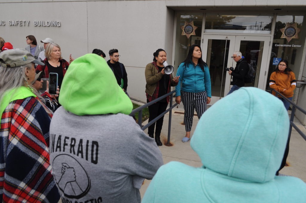 Washington Immigrant Solidarity Network coordinators Brenda Rodriguez, left, and Monserrat Padilla address a crowd of activists Sunday who gathered at the Kittitas County Jail to demand the end of a contract between the county and Immigration and Customs Enforcement. CREDIT: Enrique Pérez de la Rosa/NWPB