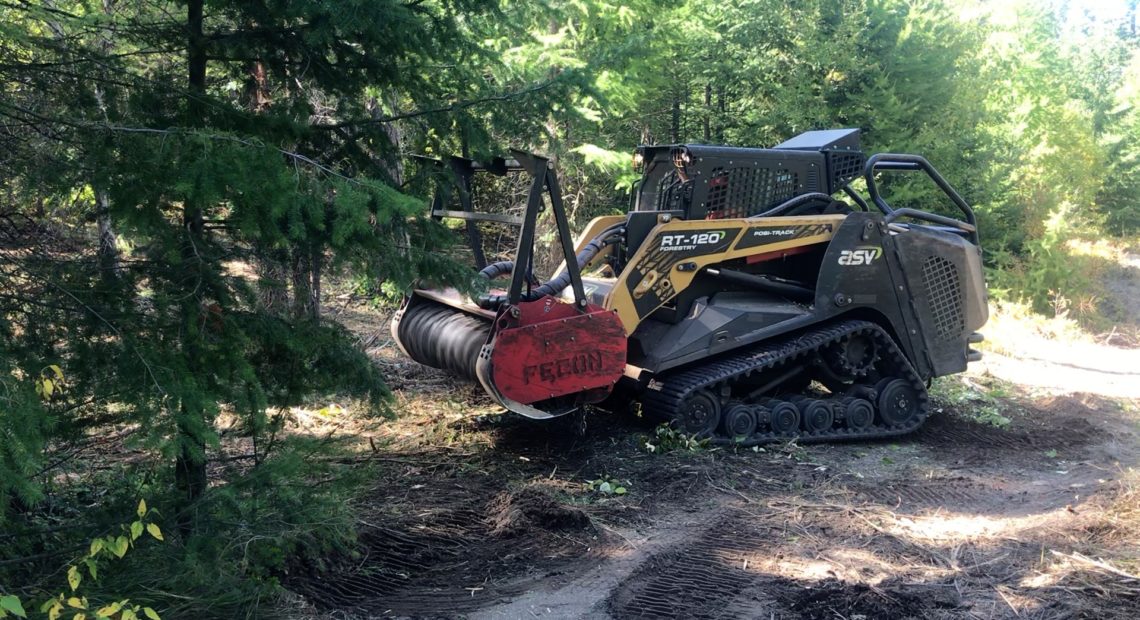 Land managers are using a masticator to help thin a dense forest outside Cle Elum, Washington. The masticator chews up the forest fuels with spinning metal teeth. It takes out whole trees at a time. CREDIT: Courtney Flatt/NWPB