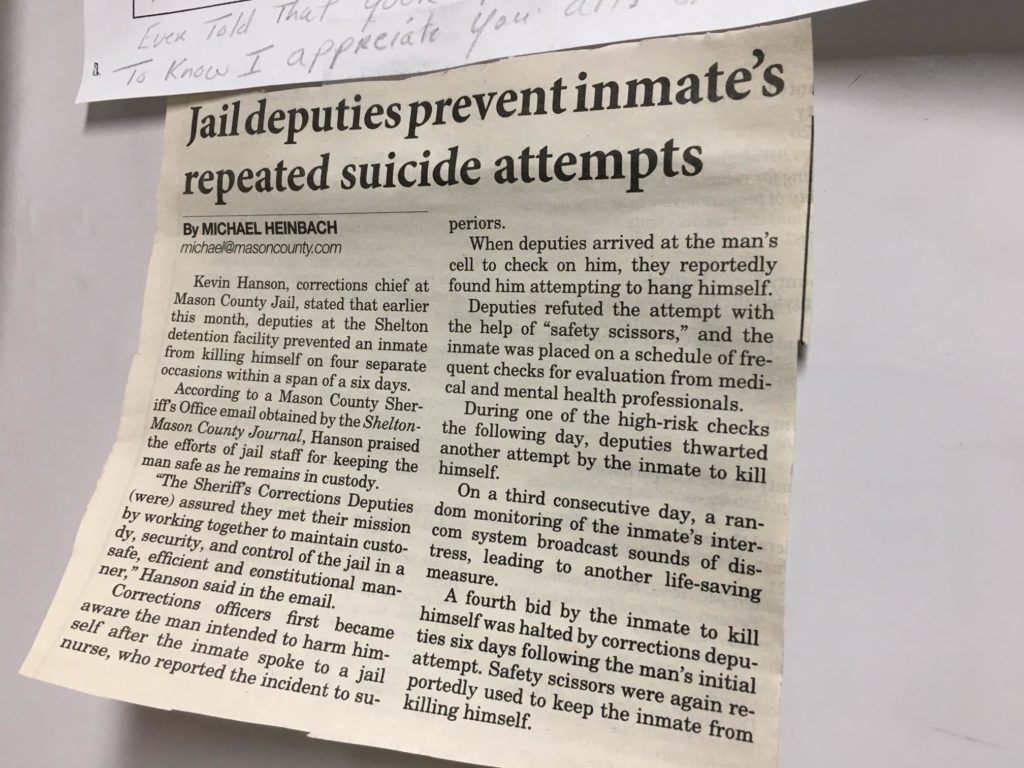 A newspaper article hanging in the Mason County Jail office talks about suicide attempts in the jail. CREDIT: Austin Jenkins/N3