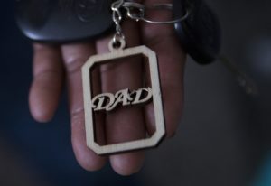 Raul holds a keychain, a gift from his daughter, at his apartment. “When you lose everything… you lose fear too,” he says in a thin voice. CREDIT: Megan Farmer/KUOW