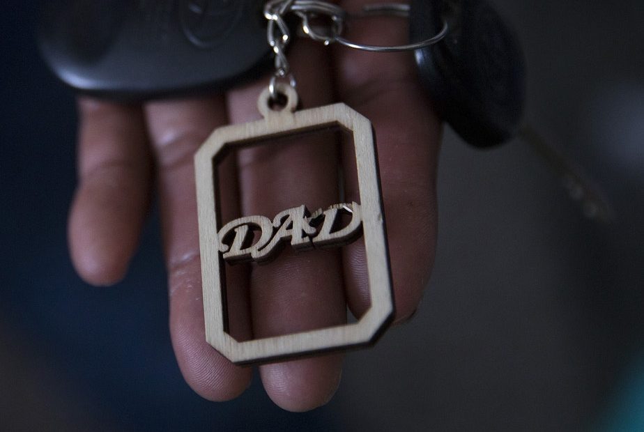 Raul holds a keychain, a gift from his daughter, at his apartment. “When you lose everything… you lose fear too,” he says in a thin voice. CREDIT: Megan Farmer/KUOW