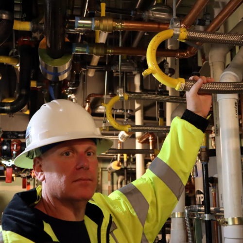 Samaritan North Lincoln Hospital facilities director Chris Lemar shows flexible piping designed to withstand earthquake shaking in the new hospital. CREDIT: Tom Banse/N3