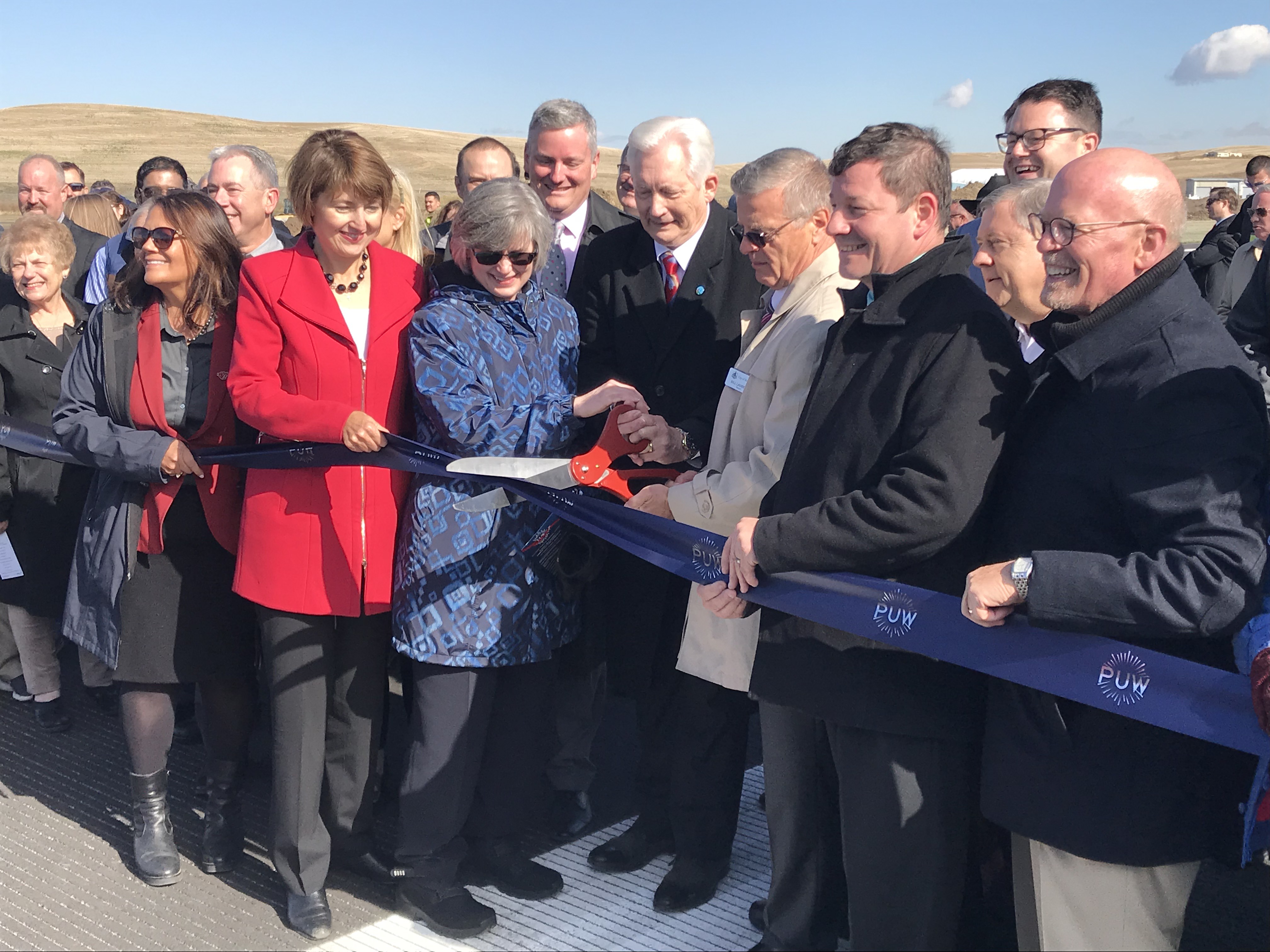 Local, state and federal officials were on hand Thursday, Oct. 10 for the ribbon cutting ceremony of the newly reopened Pullman-Moscow regional airport. U.S. Rep. Cathy McMorris Rodgers, left in red coat, praised the work of many partners. CREDIT: Cameron Sheppard/NWPB