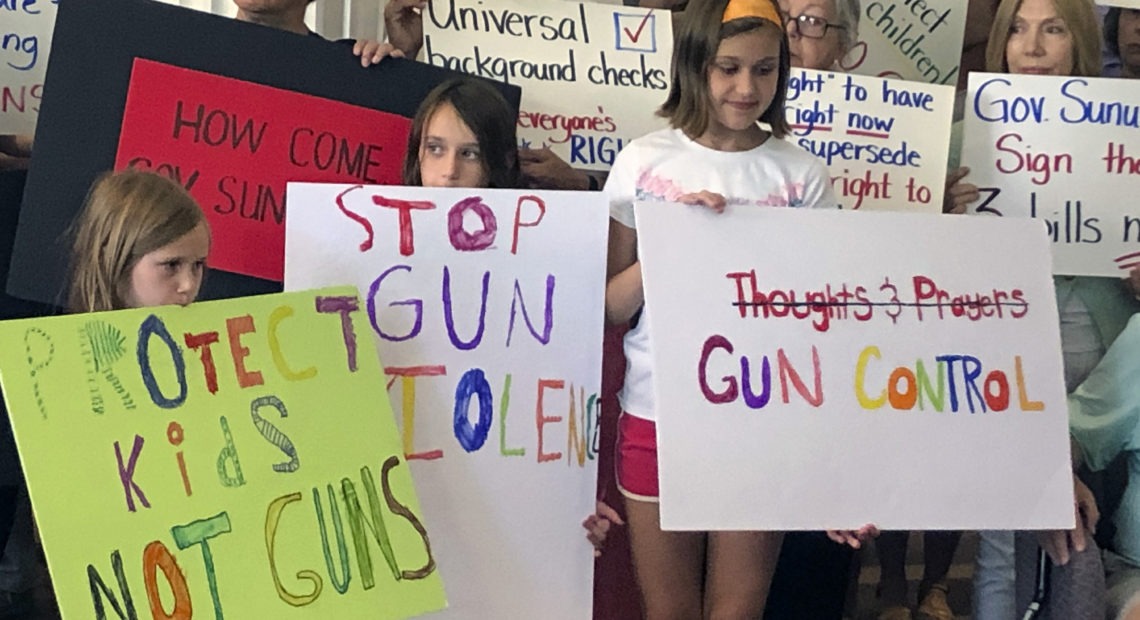 Supporters of gun control measures gather at the Legislative Office Building in Concord, N.H., in August, to urge Republican Gov. Chris Sununu to act after mass shootings in Texas and Ohio. CREDIT: Michael Casey/AP