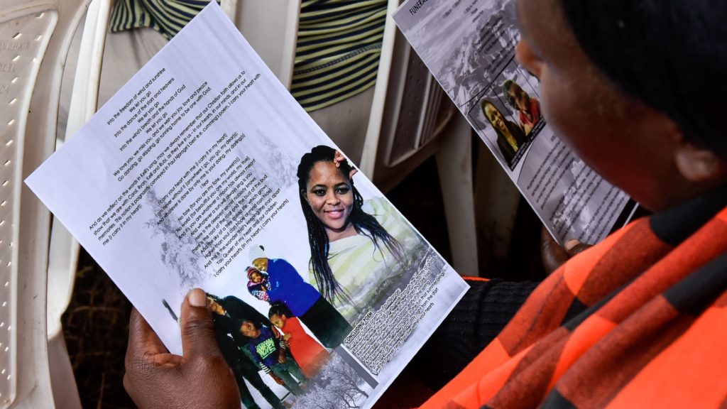 A mourner looks at pictures of four Kenyan victims of the Ethiopian Airlines crash whose remains were returned from Ethiopia this week. Suleiman Mbatiah/AFP via Getty Images