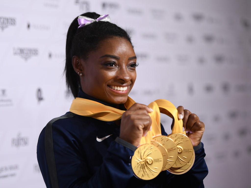 U.S. gymnast Simone Biles poses with her five gold meals at the 2019 World Championships in Stuttgart, Germany. With her wins, she becomes the most decorated gymnast ever at the world championships, with 25 total medals. Laurence Griffiths/Getty Images
