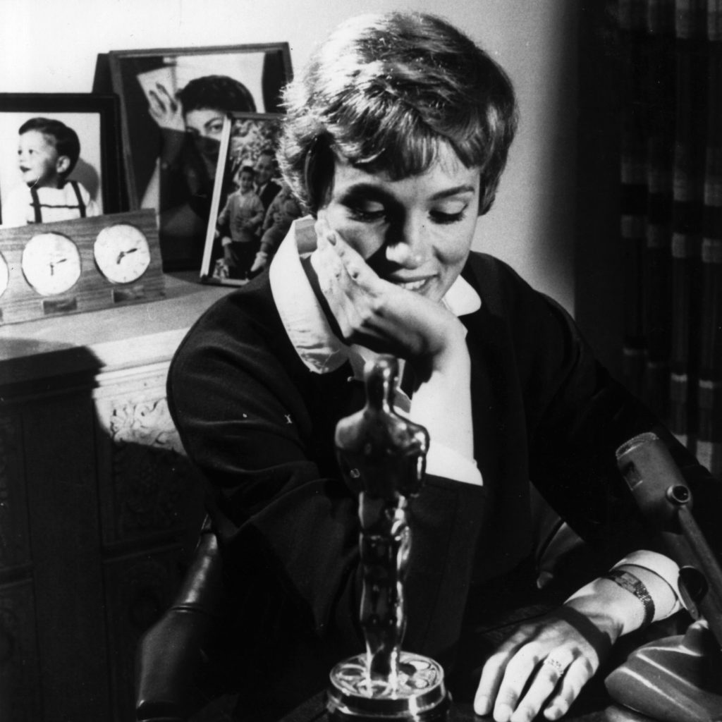 A younger Julie Andrews poses with the Academy Award she won for her role in Mary Poppins. Keystone/Getty Images