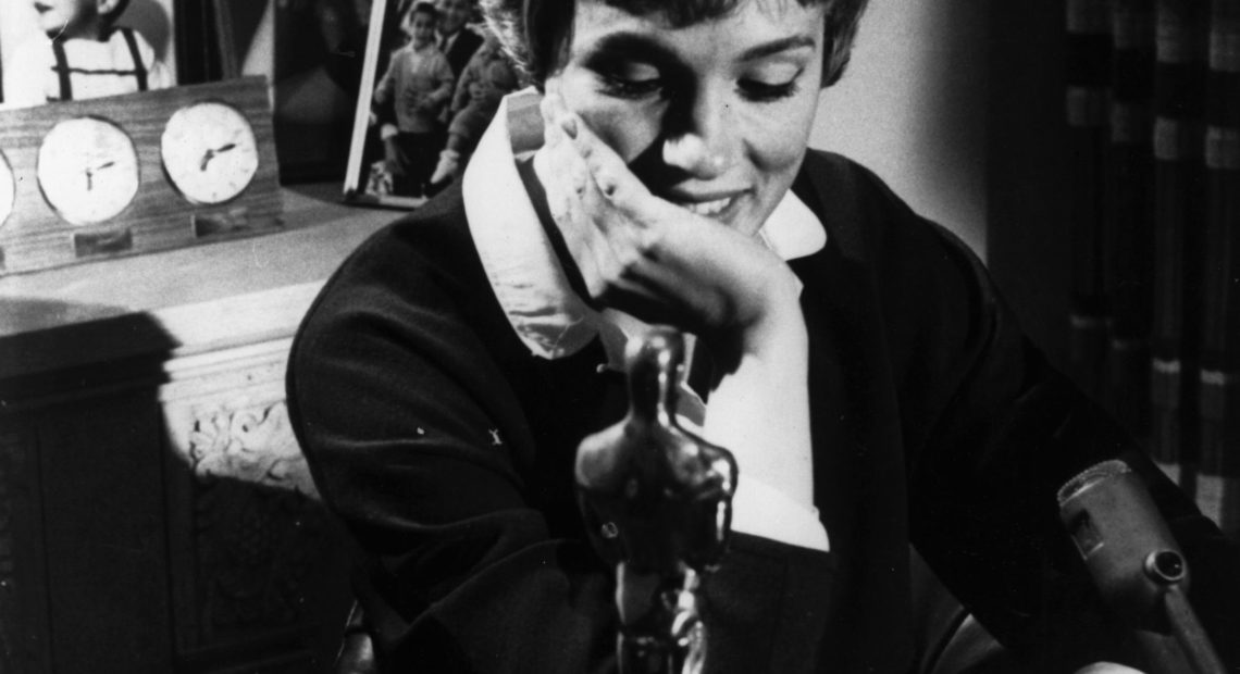 A younger Julie Andrews poses with the Academy Award she won for her role in Mary Poppins. Keystone/Getty Images