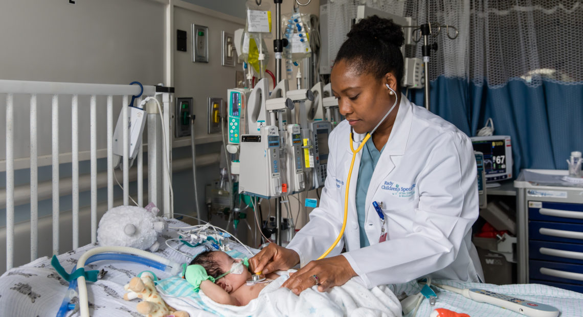 Nathaly Sweeney, a neonatologist at Rady Children's Hospital-San Diego and researcher with Rady Children's Institute for Genomic Medicine, attends to a young patient in the hospital's neonatal intensive care unit.