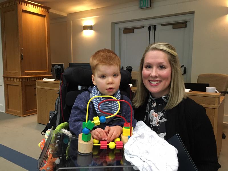 Lindsey Topping-Schuetz poses for a photo with her three-year-old son Owen before testifying about the challenges families face in obtaining state-paid developmental disabilities services.