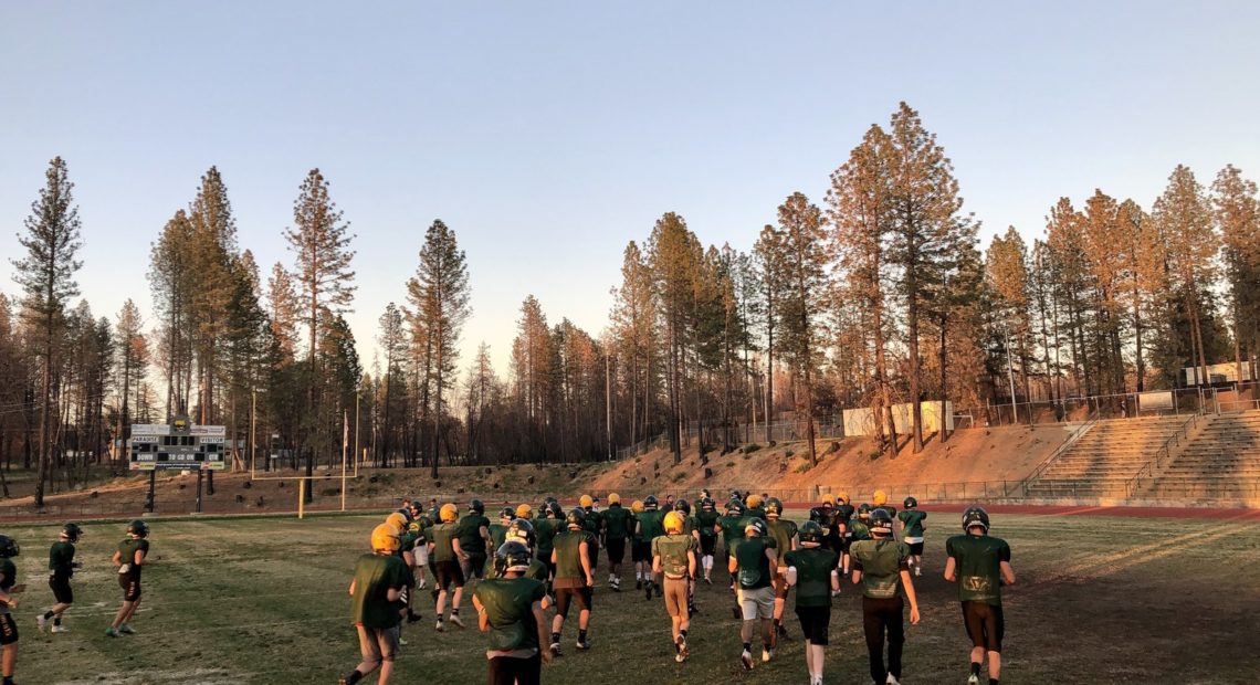 Paradise Camp fire - football team on field