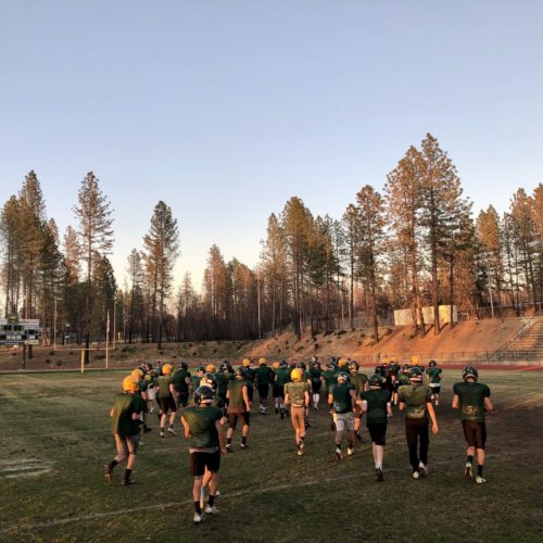 Paradise Camp fire - football team on field